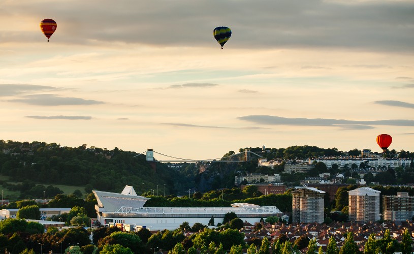 Hot air balloons flying over Ashton Gate Stadium and Clifton Suspension Bridge